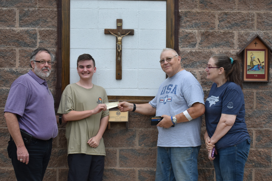 Grand Knight George Brown presents a check from Council 6451 to Jordan Bown